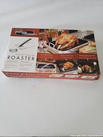 Photo of the Turkey Cannon Poultry Infusion Roaster in its original box showing product image and information on the packaging.