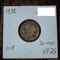 Front of the coin mounted in cardboard holder with handwritten date '1888', denomination '10c', and condition noted as 'Scratches' and graded VF25.