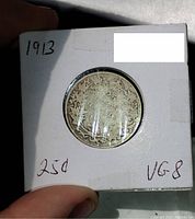 Reverse side of the 1913 Canadian 25 cent coin showing denomination and wreath design.