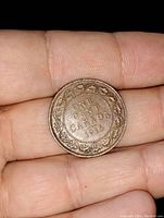 Reverse side of 1915 Canadian large cent coin showing decorative border and denomination with year 1915.
