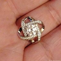 Front view of the sterling silver pendant showing the central large cubic zirconia stone and smaller stones along the intertwined loops.