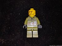 Single Lego military minifigure displayed on dark background, showing front view with detailed printed uniform and facial expression.
