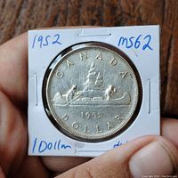 Obverse side showing the voyageur canoe with two men paddling and 'CANADA DOLLAR 1952'.