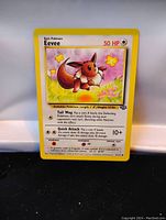 Front of the card showing Eevee artwork and card details including HP, attacks, and flavor text