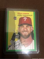 Front of the Bryce Harper baseball card showing player image, signature, team, and green heritage Prizm design.