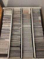 Tall box with thousands of stacked trading cards without individual viewable images.