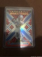 Front of Jameson Williams XR Impending Greatness rookie card with holographic design and number 096/149