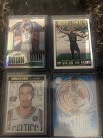 Four Jayson Tatum basketball cards showing the silver Downtown card, Road to the Finals playoff stats card, Slam Magazine card, and blue Prizm Mystique card on dark marble surface.