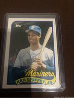 Front of 1989 Topps Ken Griffey Jr. rookie baseball card showing player in Mariners jersey with bat.