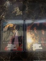 Front view of two foil trading cards featuring X-Men characters, titled No Ruby Quartz and Day of Future Present, both in plastic sleeves.
