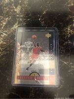 Front view of the Michael Jordan Greater Heights insert basketball card showing Jordan in red Chicago Bulls uniform mid-dunk.