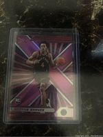 Front side of Scottie Barnes rookie Pink Prizm basketball card with dynamic pink starburst design, showing player in action.