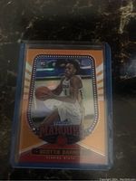 Front of Scottie Barnes rookie card with orange marquee design and action photo in Florida State uniform.