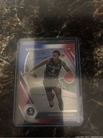 Front of Scottie Barnes rookie card showing him in Florida State uniform during basketball play.