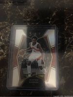 Front view of Scottie Barnes rookie card in Select Silver Prizm design, showing player in Toronto Raptors jersey with basketball and Select logo above.