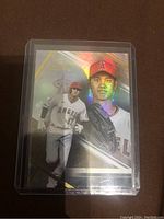Front view of Shohei Ohtani baseball card with holographic gold border and images of Ohtani in pitching and portrait poses.
