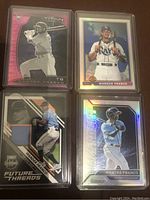 Four Wander Franco rookie baseball cards placed together, each in hard plastic protective sleeves. Shows clear visuals of card designs and memorabilia patch.