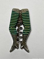 Corkscrew folded with celluloid striped legs visible.