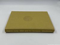 Side view of book spine showing gold cloth binding and stamped title