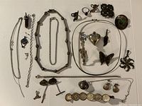 Overall assortment of sterling silver jewelry items laid out