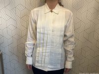 Front view of shirt on model showing pleated panel and overall fit