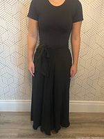Full front view of black skirt on a mannequin showing fit and length