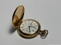 Open hunter case showing white dial with Roman numerals, sub-second dial, and Eagle Star Geneve branding.