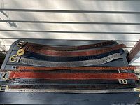 Overhead view of all 10 belts laid flat showing colours and textures
