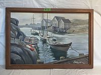 Front view of the framed vintage nautical oil painting showing boats, rocky shoreline, and buildings.