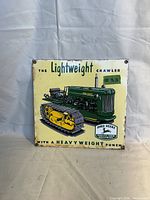 Photo of vintage porcelain John Deere sign with the Lightweight Crawler tractor illustration and text.