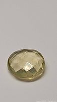 Natural lemon citrine gemstone approximately 4.69 carats, displayed on plain background showing checkerboard faceting.