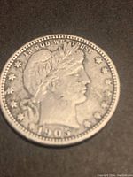 Image of front (obverse) side of 1905 USA Barber Quarter showing Liberty head, date 1905, and surrounding stars.