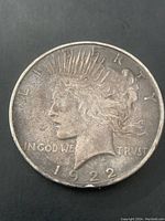 Front view of 1922 Liberty (Peace) silver dollar coin showing Lady Liberty profile, LIBERTY inscription, date, and TRVST wording.