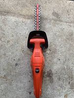 Top view of the Black & Decker electric chain saw with power switch and blade guard visible.