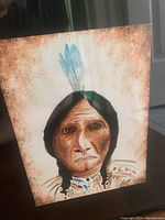 Original watercolour painting showing the portrait of an Indigenous person with braided hair and feathers, signed Zanetti.
