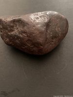 Meteorite sample showing irregular shape and pitted dark surface