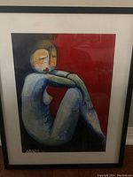 Full view of the framed painting showing the full seated nude figure with the signature.