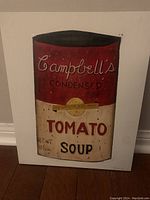 Full view of the painting showing the Campbell's Condensed Tomato Soup can with text and colors.