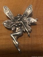 Close-up of the sterling silver Art Nouveau style fairy pin showing full body and wings.