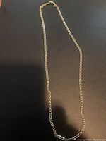 Full view of the 24-inch sterling silver chain with gold plating accents laid out flat.
