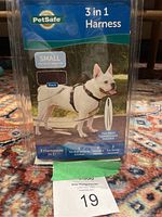 Front of original packaging showing PetSafe 3 in 1 harness for small dogs, black color, with image of dog wearing harness and key product features.