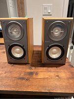Front view of both Sony SS-CRB5 speakers showing the simulated wood cabinets and silver drivers.