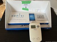 Image showing the vintage White-Rodgers thermostat in front of the Emerson Sensi box.