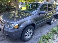 Front passenger-side three-quarter view showing body panels, wheel and headlight