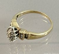 Side angle view of the 10K gold ring with cluster diamond setting