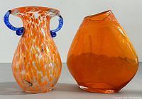Pair of mid-century modern art glass vases side by side on a flat surface, showing size and shape contrast.