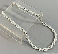 Chain displayed on clear acrylic stand showing overall design