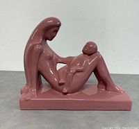 Front view of the mauve glazed Haeger pottery statue showing the seated mother holding the child on her lap.