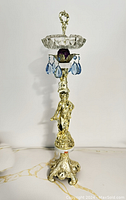 Full view of vintage Italian standing ashtray showing ornate silver-tone base, cherub figure, and faceted crystal ashtray with blue and purple crystal accents on top.