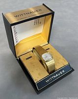 Vintage Wittnauer wristwatch in original box, showing the watch resting on a velvet cushion inside the branded case